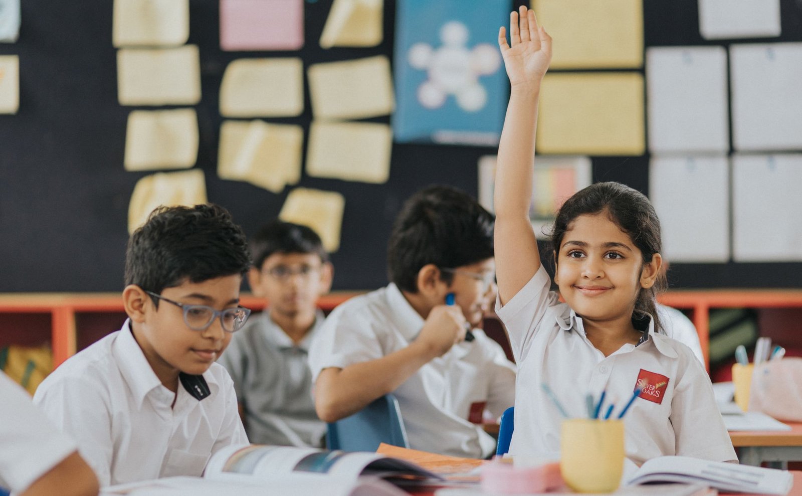 Silver oaks primary student raised hand golden